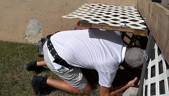 A home inspection protects your investment. (Pictured: Joel Schupp, home inspector from Sharp Eye Inspections, inspecting a crawl space.